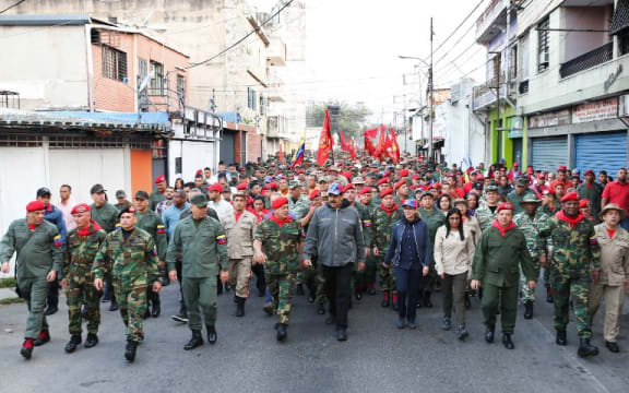 Handout picture released by the Venezuelan presidency showing Venezuela's President Nicolas Maduro (C) attending a military ceremony