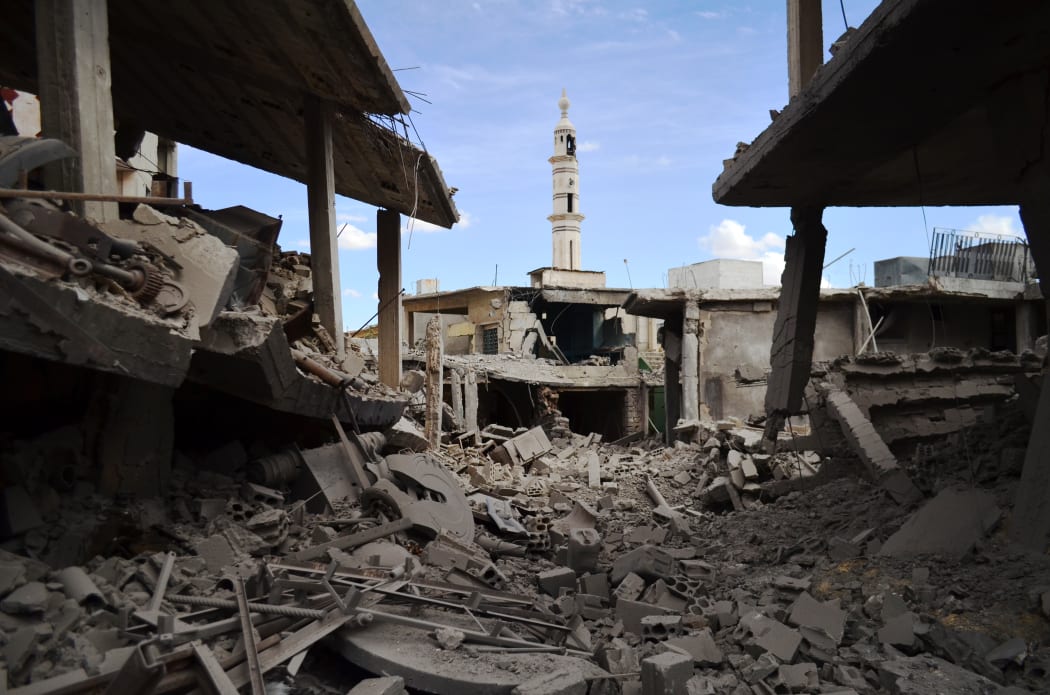 A picture taken on September 30, 2015 shows damaged buildings and a minaret in the central Syrian town of Talbisseh in the Homs province.