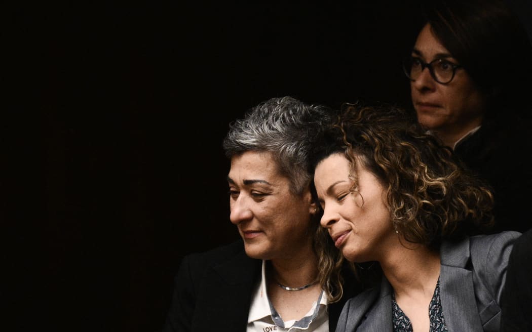 Visitors react after the parliamentary vote on same-sex marriage in Athens, on 15 February, 2024.  (Photo by Angelos TZORTZINIS / AFP)
