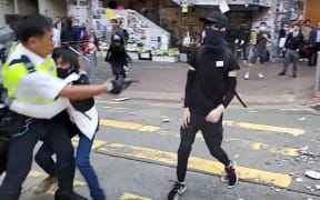 A video grab taken from Cupid News on 11 November, 2019 shows a police man (L) shooting a pro-democracy protester in the chest during a protest in Sai Wan Ho district, in Hong Kong.