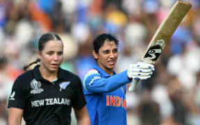 India's Smriti Mandhana (R) celebrates after scoring a century against New Zealand off the bowling of Jess Kerr.