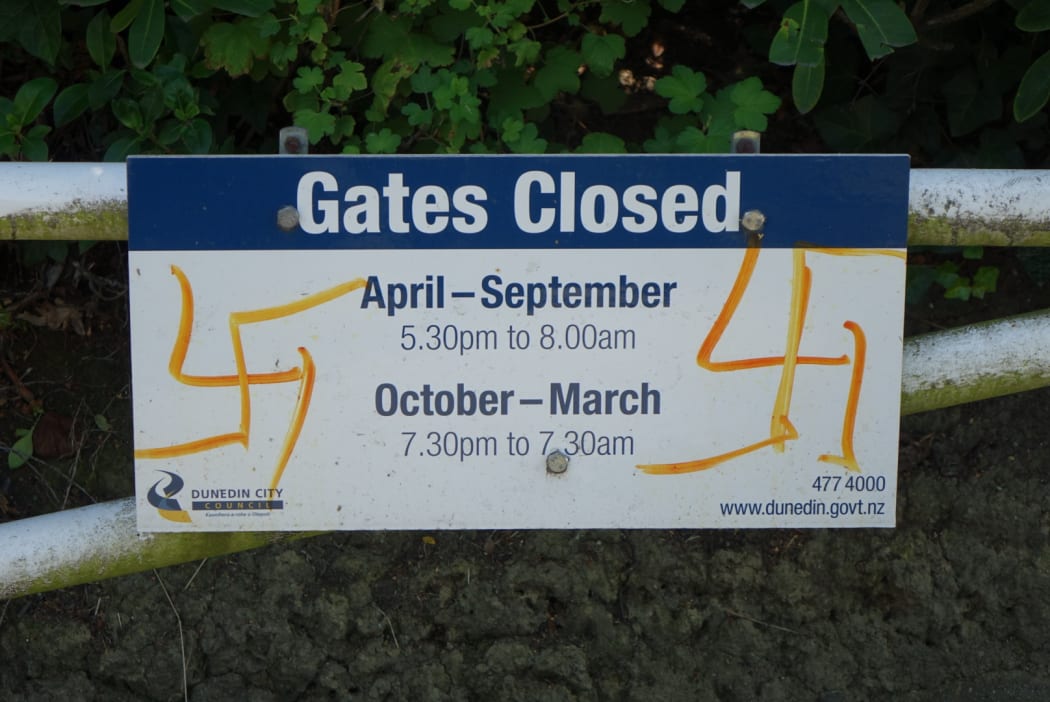 A sign at the cemetery has also been defaced with a swastika.