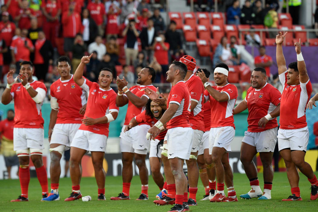 Tonga's players celebrate after retiring captain Siale Piutau (c) kicked a conversion in the final play of the game.