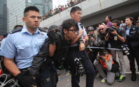 Pro-democracy protesters are arrested and removed from the financial district, central Hong Kong.