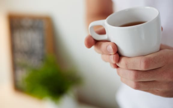 Image of cup of tea in male hands