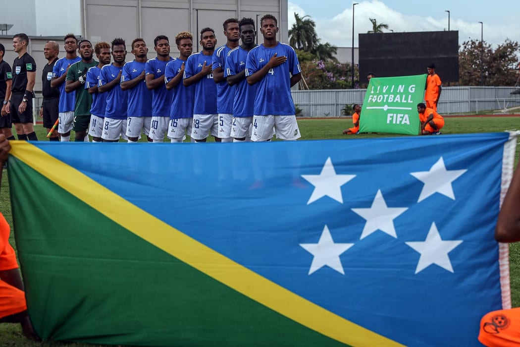 Solomon players sing the anthem before their match against Vanuatu