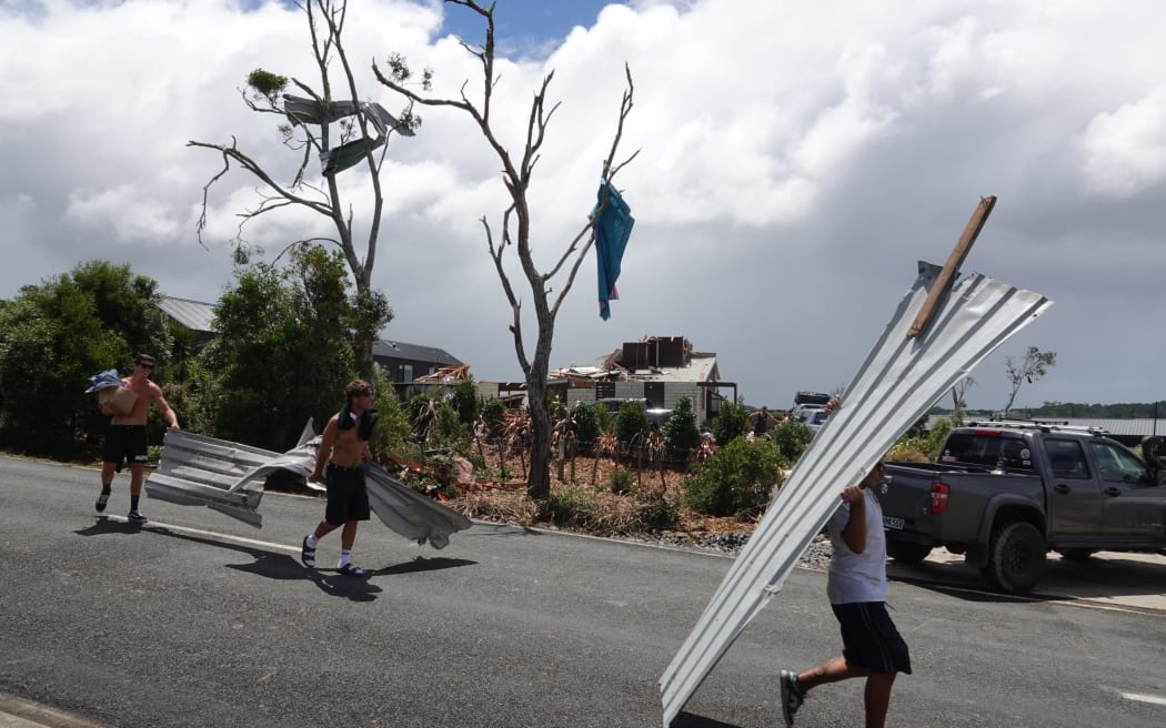 Volunteers cleaning up on Old Waipu Road after the Mangawhai tornado, 26 January, 2025.