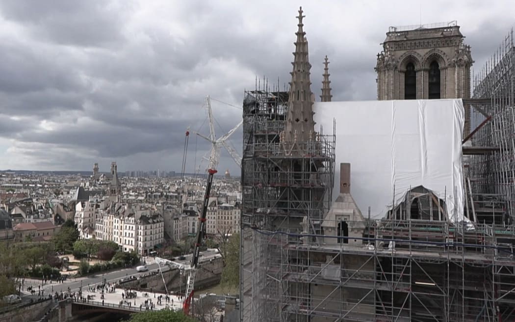 This video grab created from an AFP video taken on April 11, 2024, shows Paris Notre-Dame cathedral undergoing restoration since the devastating fire that ravaged it on April 15, 2019. A tender for the creation of contemporary stained-glass windows was launched on April 11, 2024. The iconic Parisian monument is scheduled to reopen in December 2024. (Photo by Mathilde BELLENGER / AFP)