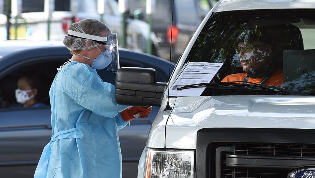 People are tested for Covid-19 at a drive through testing site sponsored by the city at Camping World Stadium on July 8, 2020 in Orlando, Florida.