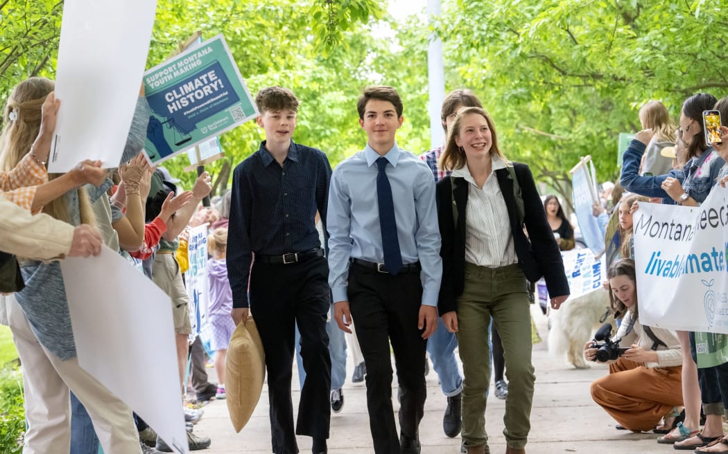 This picture provided by Our Children's Trust shows plaintiffs in the landmark Held vs Montana climate change lawsuit arrive to the Lewis and Clark County Courthouse on June 13, 2023 in Helena, Montana. In a landmark climate trial, a Montana court on August 14, 2023 ruled in favor of a group of youths who accused the western US state of violating their rights to a clean environment. District Court Judge Kathy Seeley said a state law preventing agencies from considering the impacts of greenhouse gases when issuing permits for fossil fuel development was unconstitutional. The case, Held v. State of Montana -- brought by plaintiffs ranging in age from five to 22 -- has been closely watched because it could bolster similar litigation that has been filed across the country.