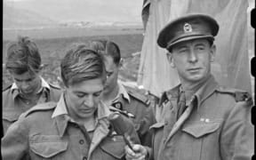 Flight Sergeant A G Newman records his message to be broadcast in NZ, with Archibald Curry, of the NZ Broadcasting Unit, April 1944.