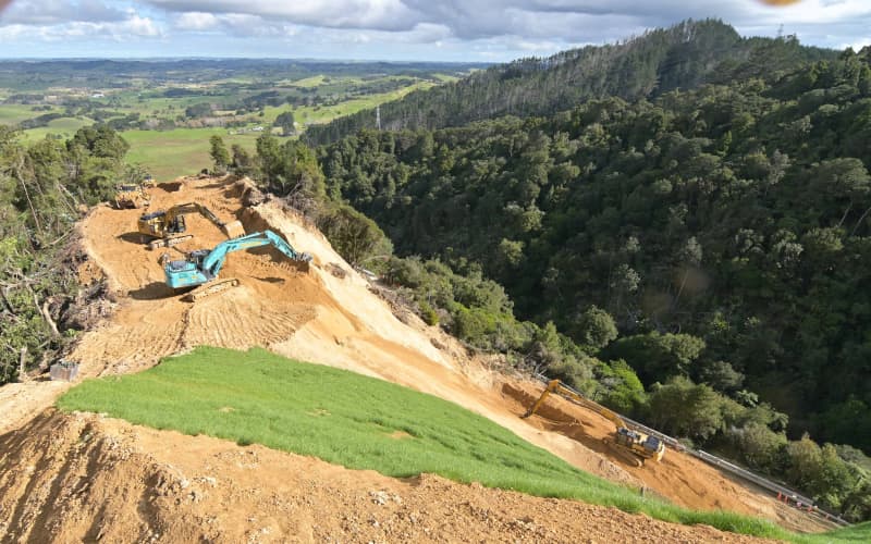 Excavators at work on the ridgeline above Kauri Tree Corner, where two fresh slips stymied plans to reopen State Highway 1 over the Brynderwyns this week.