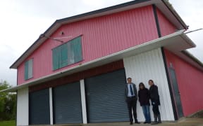 Andrew Bealing, Bonnie Packer and Vanda Packer outside the rowing club building.