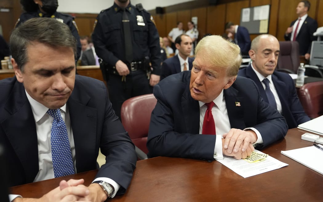 Former President Donald Trump speaks to his attorney Todd Blanche before the start of proceedings in Manhattan Criminal Court, Tuesday, May 28, 2024, in New York.