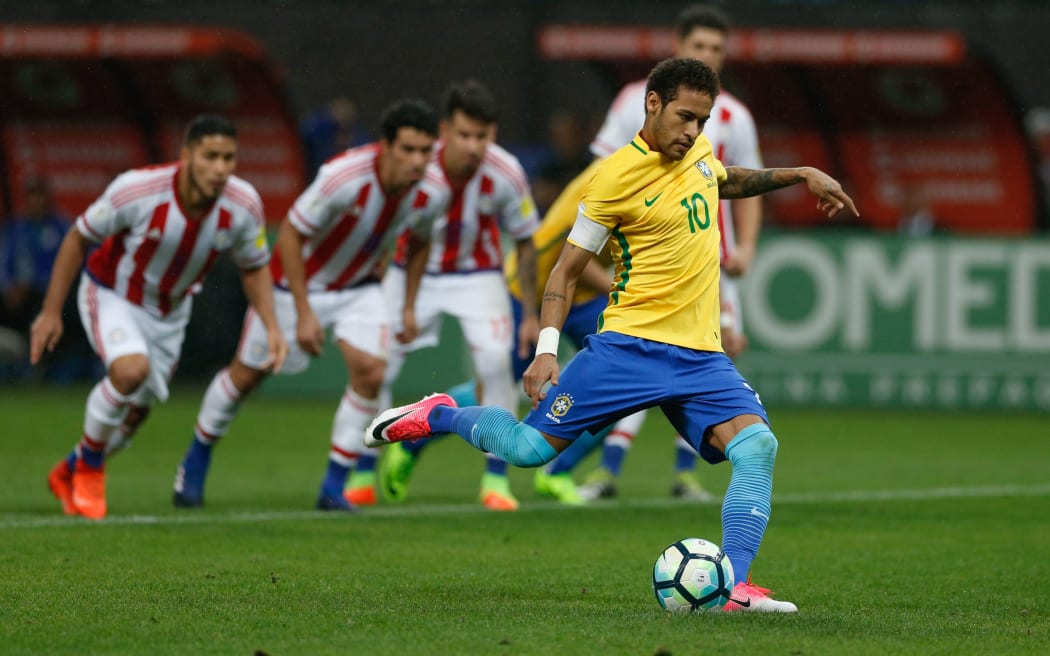 Brazilian forward Neymar takes a penalty kick against Paraguay in their World Cup qualifier.