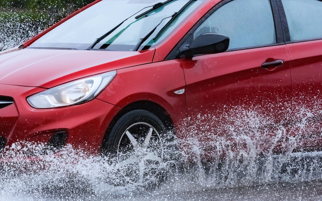 motion car rain big puddle of water spray from the wheels