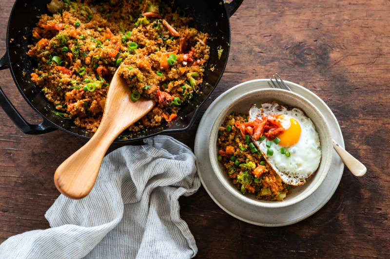 Stir-fried quinoa, broccoli and kimchi with fried eggs.