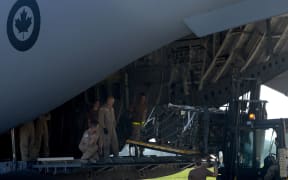 Canadian and Czech soldiers load boxes of ammunition into the Canadian C-17 Globemaster III army plane which took them to Iraq last year.