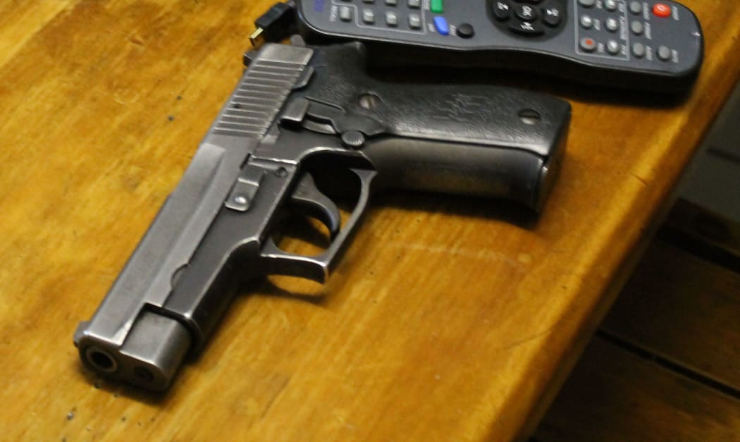 Gun on table.