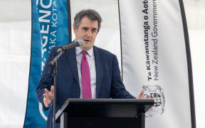 Housing Minister Chris Bishop at lectern