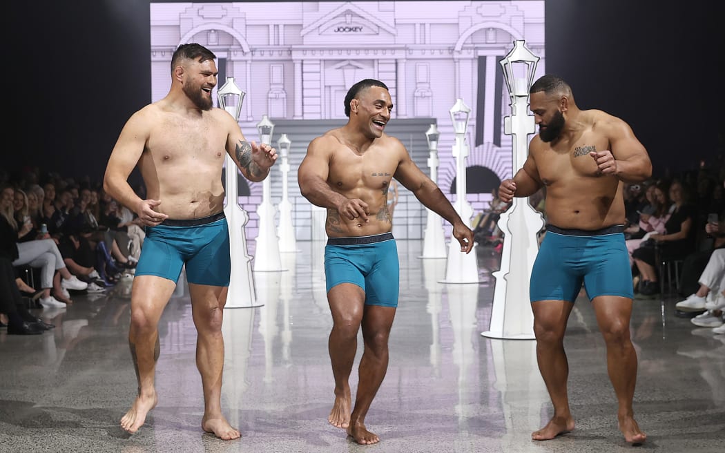 AUCKLAND, NEW ZEALAND - AUGUST 31: Angus Ta'avao, Sevu Reece and George Bower walk the runway during the Jockey show during New Zealand Fashion Week 23: Kahuria at Viaduct Events Centre‎ on August 31, 2023 in Auckland, New Zealand.