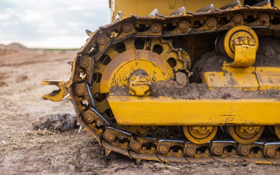 Yellow Tractor on caterpillar tracks, tractor tracks