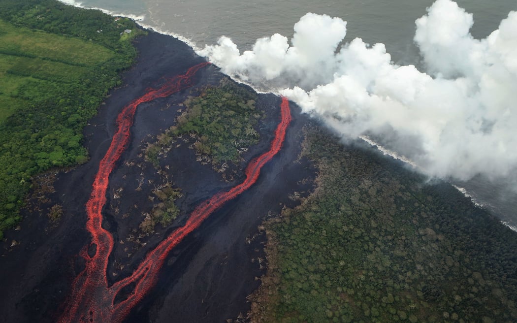 Steam plumes rise as lava enters the Pacific Ocean, after flowing to the water from a Kilauea volcano fissure on Hawaii's Big Island.