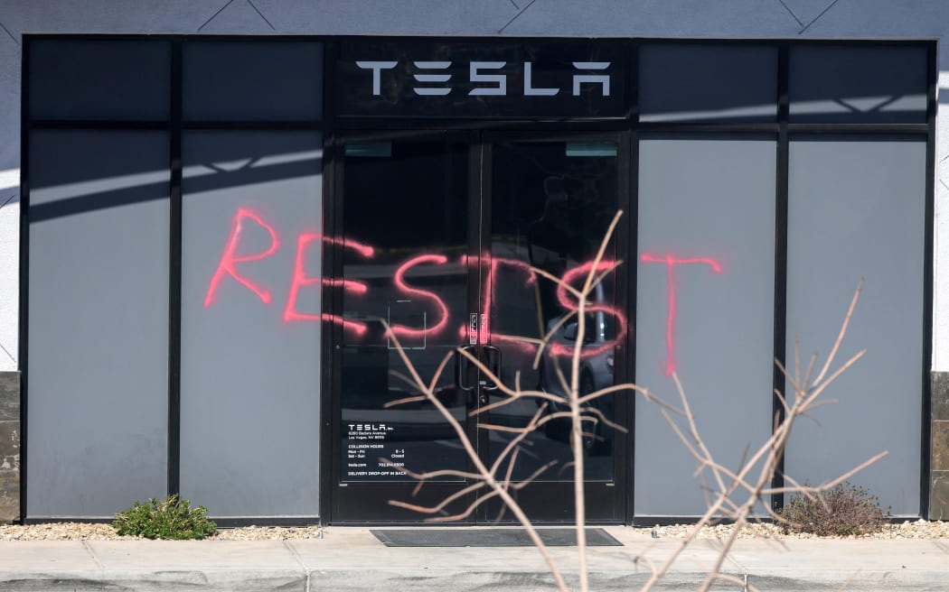 (FILES) The word "RESIST" is shown spray painted on the entrance of a Tesla Collision Center after an individual used incendiary devices to set several vehicles on fire on March 18, 2025 in Las Vegas, Nevada. A man who allegedly set fire to five Teslas and sprayed them with bullets from a semi-automatic rifle appeared in a US court March 27 facing federal arson charges, the Department of Justice said.
Paul Hyon Kim, 36, is suspected of being behind a costly assault on a Tesla business in Las Vegas, one of the most spectacular of a wave of attacks that have targeted Elon Musk's electric car brand as anger rises over government funding cuts he is overseeing. (Photo by Ethan Miller / GETTY IMAGES NORTH AMERICA / AFP)
