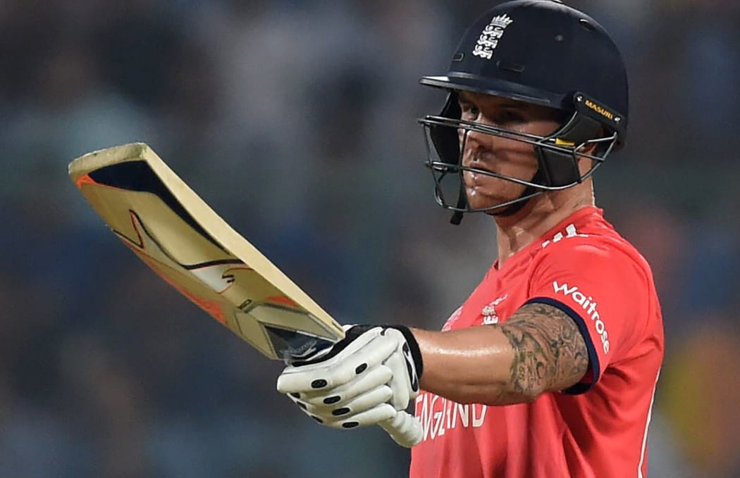 England's Jason Roy raises his bat after scoring a half century during the World T20 cricket semi-final match between England and New Zealand