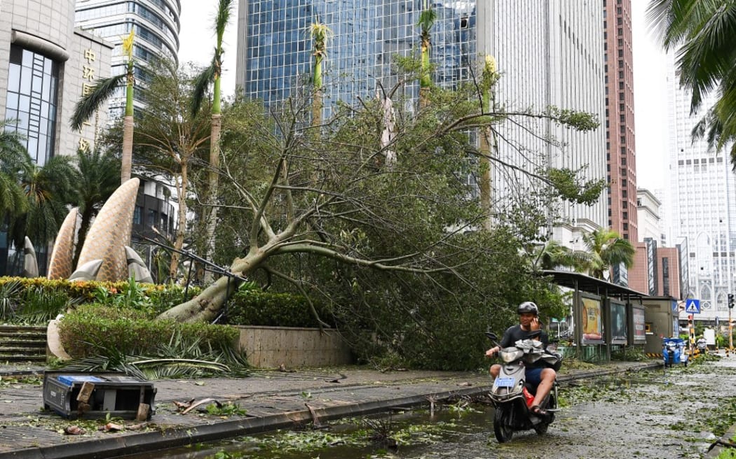 (240907) -- HAIKOU, Sept. 7, 2024 (Xinhua) -- A fallen tree is seen on a street in Haikou, south China's Hainan Province, Sept. 7, 2024.
  Super Typhoon Yagi pounded south China's island province of Hainan with heavy rain and gusty winds, leaving at least two people dead and 92 injured, local authorities said Saturday.
  As winds and rainfall subsided, Hainan downgraded its typhoon alert and initiated swift recovery operations across the province. (Xinhua/Yang Guanyu) (Photo by Yang Guanyu / XINHUA / Xinhua via AFP)