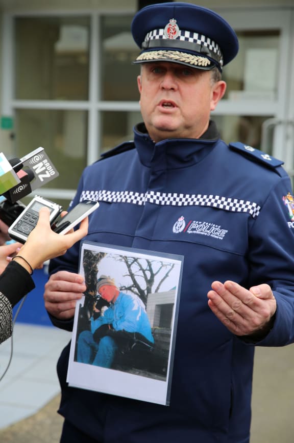 Superintendent Gary Knowles with a picture of the suspect, Jonathan Tully.