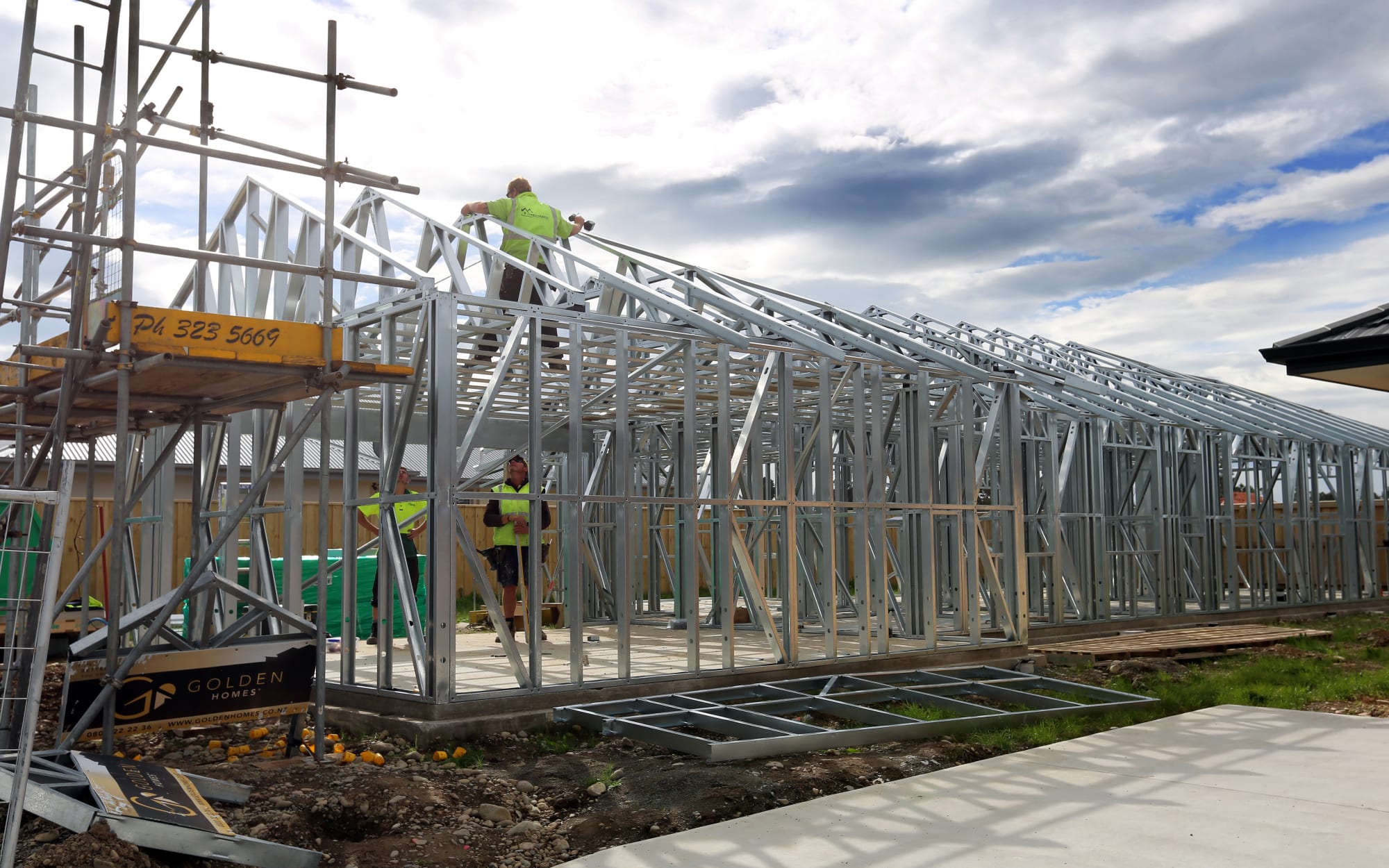 Builders work on one of the hundreds of new houses to spring up in Rolleston since 2011