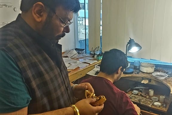 Happy and his son Navneet at their jewellery workshop, Hunter's Corner.
