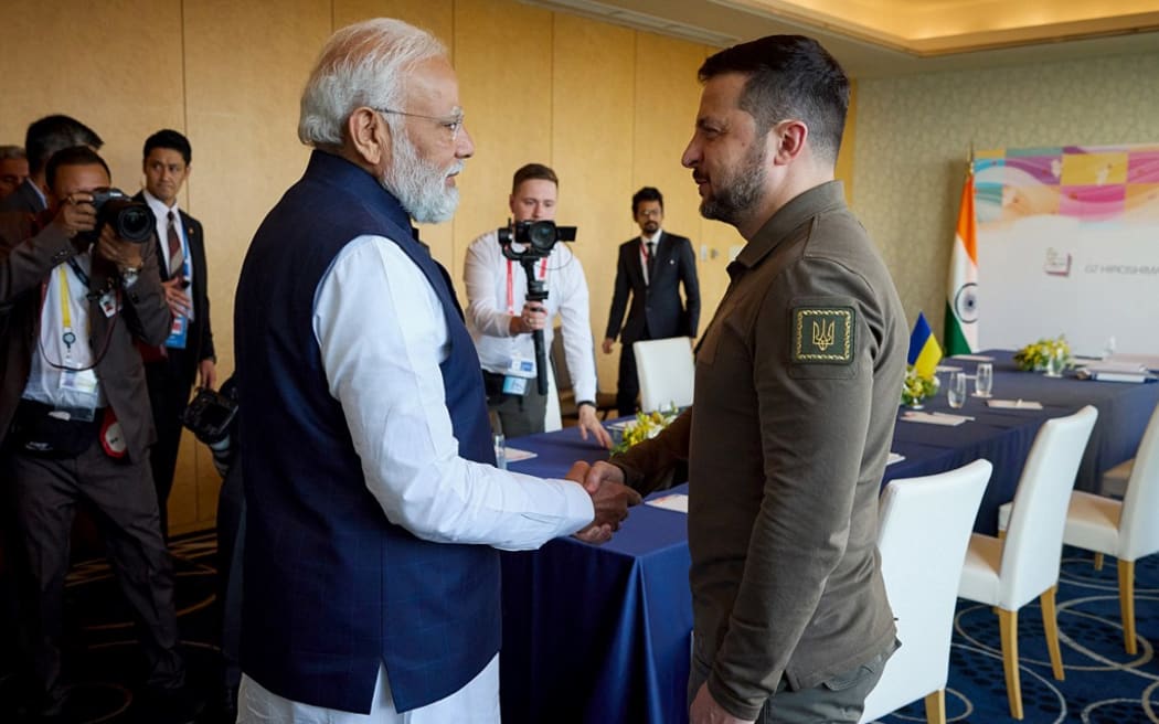 This handout photograph taken and released by the Ukrainian Presidential Press Service on May 20, 2023, shows Ukraine's President Volodymyr Zelensky (R) shaking hands with India's Prime Minister Narendra Modi (L) in Hiroshima, on the second day of the G7 Summit Leaders' Meeting. Zelensky's surprise summit appearance -- he had been expected to appear by video call -- is his furthest foray from Kyiv since Russia's invasion began 15 months ago. (Photo by Handout / Ukrainian Presidential Press Service / AFP) / -----EDITORS NOTE --- RESTRICTED TO EDITORIAL USE - MANDATORY CREDIT "AFP PHOTO / HANDOUT / UKRAINIAN PRESIDENTIAL PRESS SERVICE" - NO MARKETING - NO ADVERTISING CAMPAIGNS - DISTRIBUTED AS A SERVICE TO CLIENTS  - NO ARCHIVES
