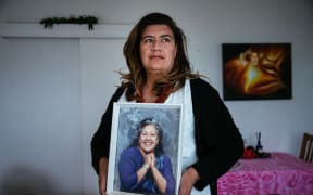Auckland councillor Josephine Bartley with a picture of her mother Ruth, who she says had a chronic gambling problem which led to her eventually losing the family home.