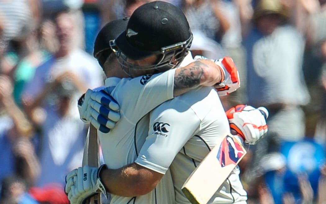 Corey Anderson embraces Brendon McCullum after the latter scored the world's fastest test century.