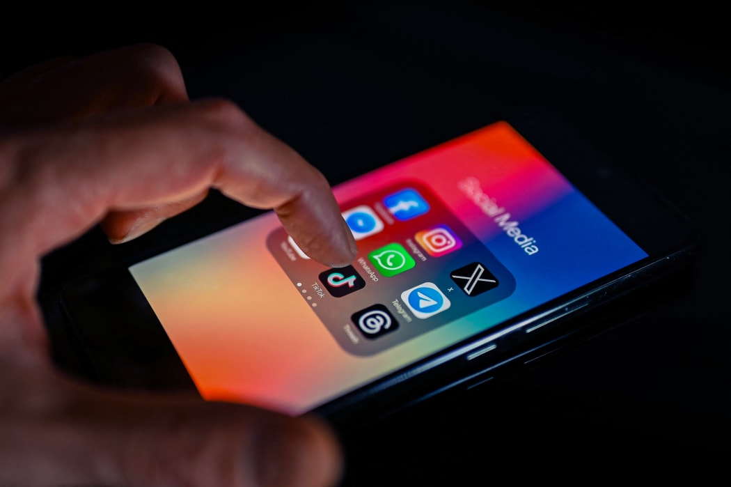 Close - up finger pointing to TokTok mobile app displayed on a smartphone screen alongside that of X,Whatsapp,Facebook,Messenger,Threads,Telegram, on August 15, 2023, in Brussels, Belgium. (Photo illustration by Jonathan Raa/NurPhoto) (Photo by Jonathan Raa / NurPhoto / NurPhoto via AFP)