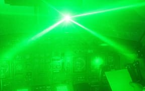 A simulated laser strike on an aircraft cockpit. The pilot of a cargo plane has described an explosion of green light when his 767 was hit in July 2022.