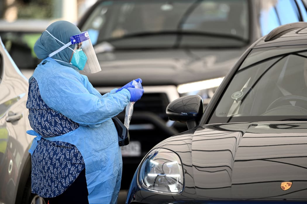 A health worker registers a resident at a Covid-19 drive-through testing site on Bondi Beach in Sydney on 17 June, 2021.