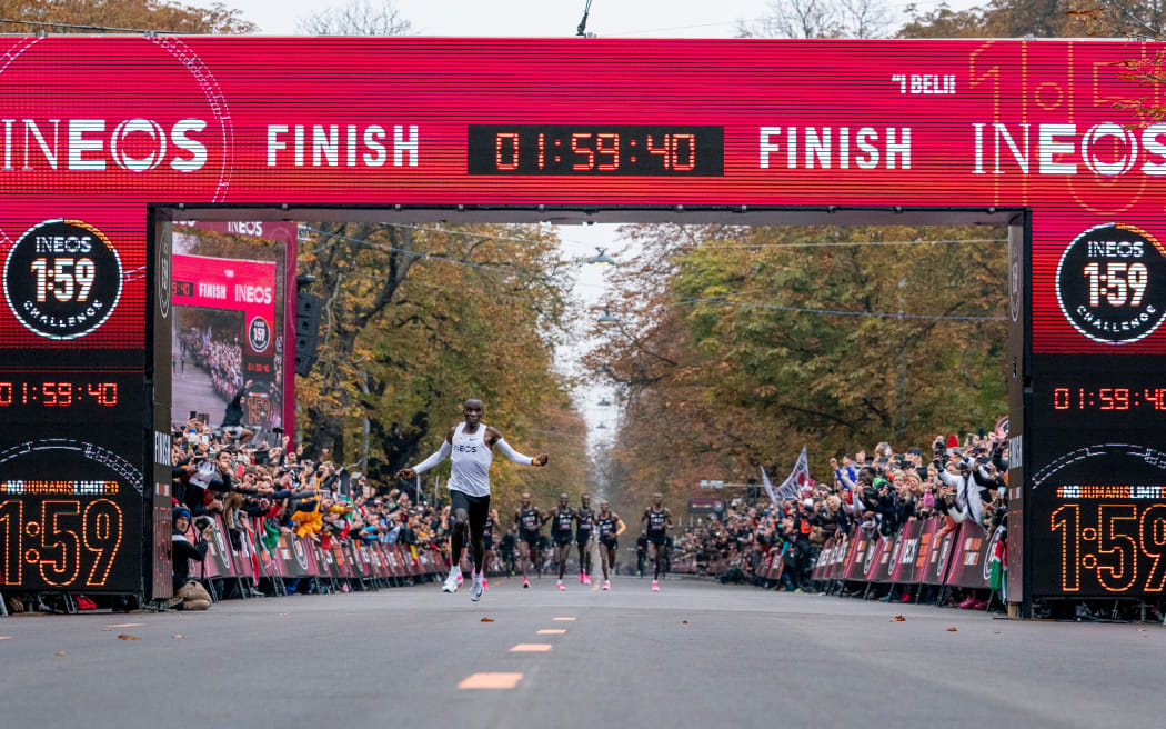 Eliud Kipchoge celebrates as he crosses finish line and makes history to become the first human being to run a marathon in under 2 hours. The INEOS 1:59 Challenge in Vienna, in 2019.