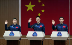 Astronauts Chen Dong, Chen Zhongrui, and Wang Jie at a news conference ahead of their Shenzhou-20 mission at Jiuquan Satellite Launch Center in Gansu, China, on 23 April.
