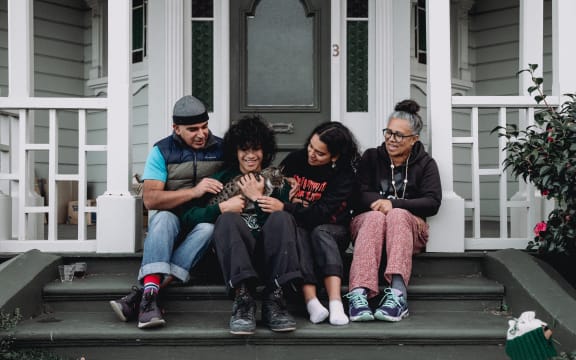 (L-R) Adel, Haami holding cat Googoosh, Carmel, and Maxine on the steps of their home
