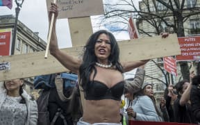 Sex Workers and supporters protest as French lawmakers take part in a final debate on a bill that would make it illegal to pay for sex.