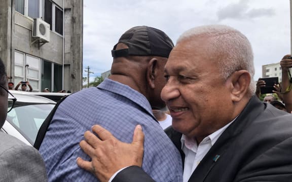 Bainimarama embraced by a supporter.