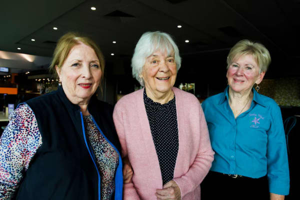 ACT Shirley Club inaugural members Shirley Kenney, Shirley Cramp and Shirley Scholte stand linking arms.