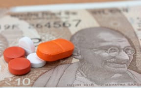 Concept of the affordable medicine in India due to generic drugs on Indian currency notes as background