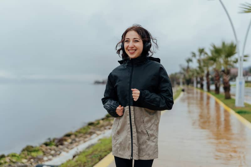 A woman exercising in the rain.
