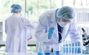 Asian scientist team researching in laboratory.