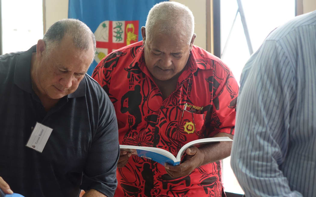 A retired member of the Fiji military, Jay Soko, browses a book about Laucala Bay at the Suva equivalent of the RSA.