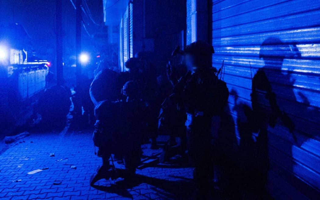 This handout picture released by the Israeli army on 15 November, 2023, shows soldiers during a military operation at Al-Shifa hospital in Gaza City, amid continuing battles between Israel and the Palestinian militant group Hamas.
